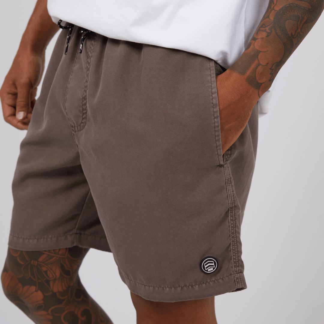 Stewarts Menswear St Goliath Illusion short. Made from 100% recycled material, Its faded look adds a touch of trendiness while the quick dry micro fibre material ensures comfort. Colour is Taupe. Image shows close up of model wearing St Goliath Illusion shorts.