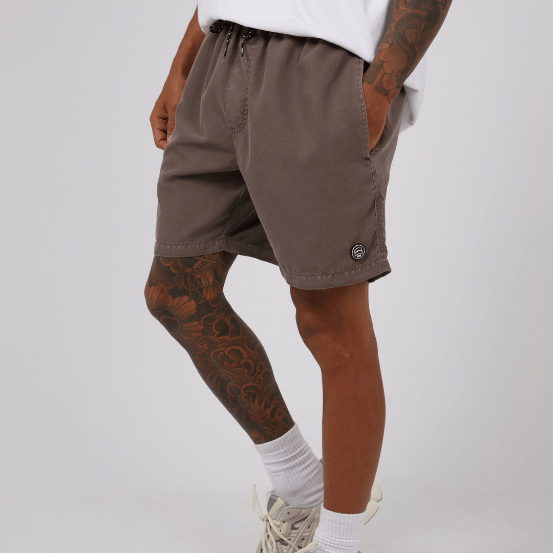 Stewarts Menswear St Goliath Illusion short. Made from 100% recycled material, Its faded look adds a touch of trendiness while the quick dry micro fibre material ensures comfort. Colour is Taupe. Image shows close up of model wearing St Goliath Illusion shorts.