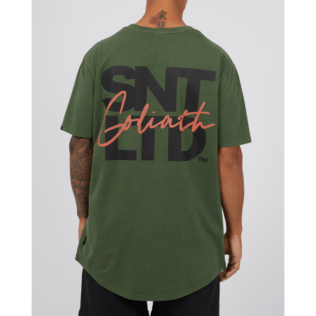 Stewarts Menswear St Goliath Overwrite Tee. A relaxed fit, oversize tee with large St Goliath print on back with smaller front chest print. Photo shows back view of model wearing St Goliath Overwrite Tee.