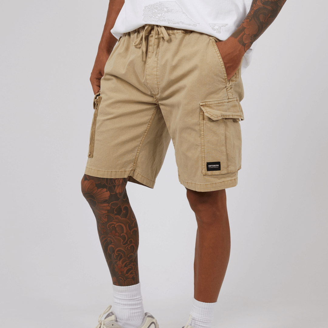 stewarts Menswear St Goliath Ripstop Cargo Short. Colour is sand. Photo shows close up of model wearing St Goliath Ripstop Cargo Short.