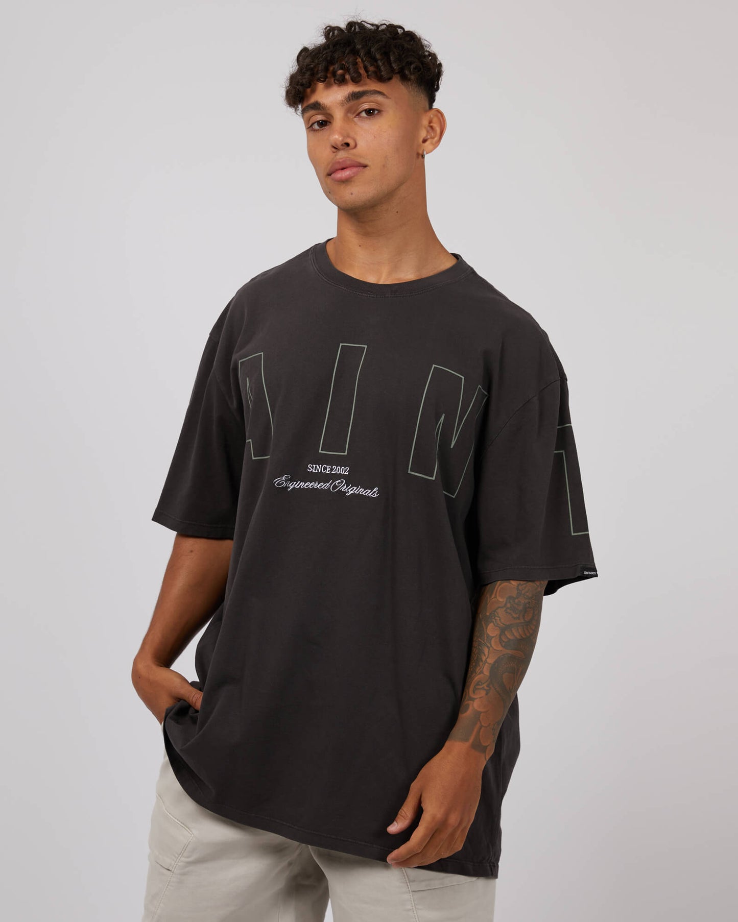 Stewarts Menswear St Goliath Riser Tee. Colour is black. Photo shows model wearing St Goliath Riser Tee, front view.