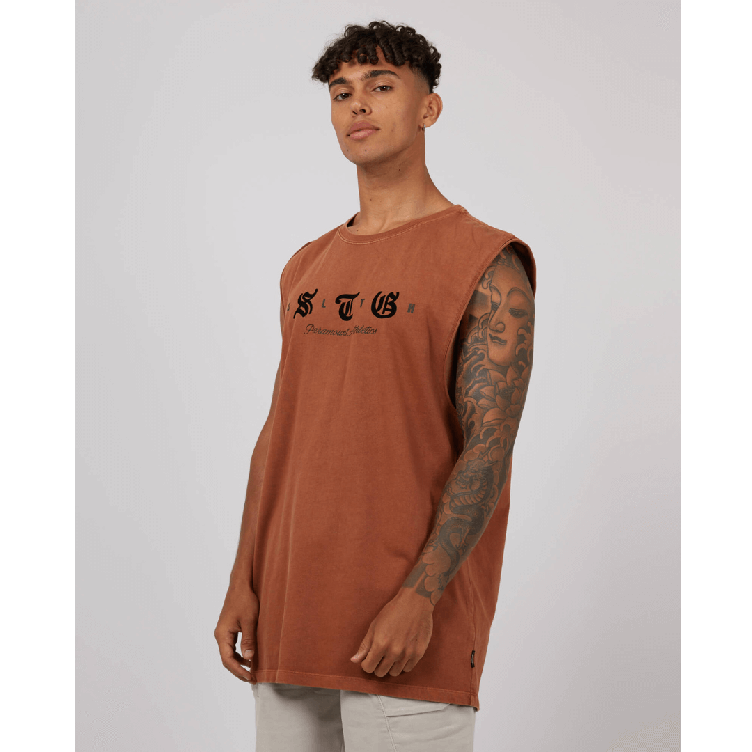 Stewarts Menswear St Goliath Silhouette Muscle Tee. Colour is Mocha. Black flocked branding on front. Photo shows model wearing St Goliath Silhouette Muscle Tee, front view.