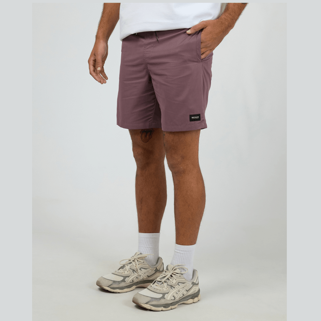 Model wearing St Goliath Swim Volley in burgundy available at Stewarts Menswear in Mullumbimby