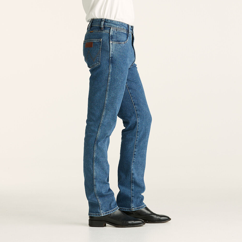 Stewarts Menswear Wrangler Classics Straight Jeans. Colour is Original Stone. Photo shows model wearing wrangler jeans side view.