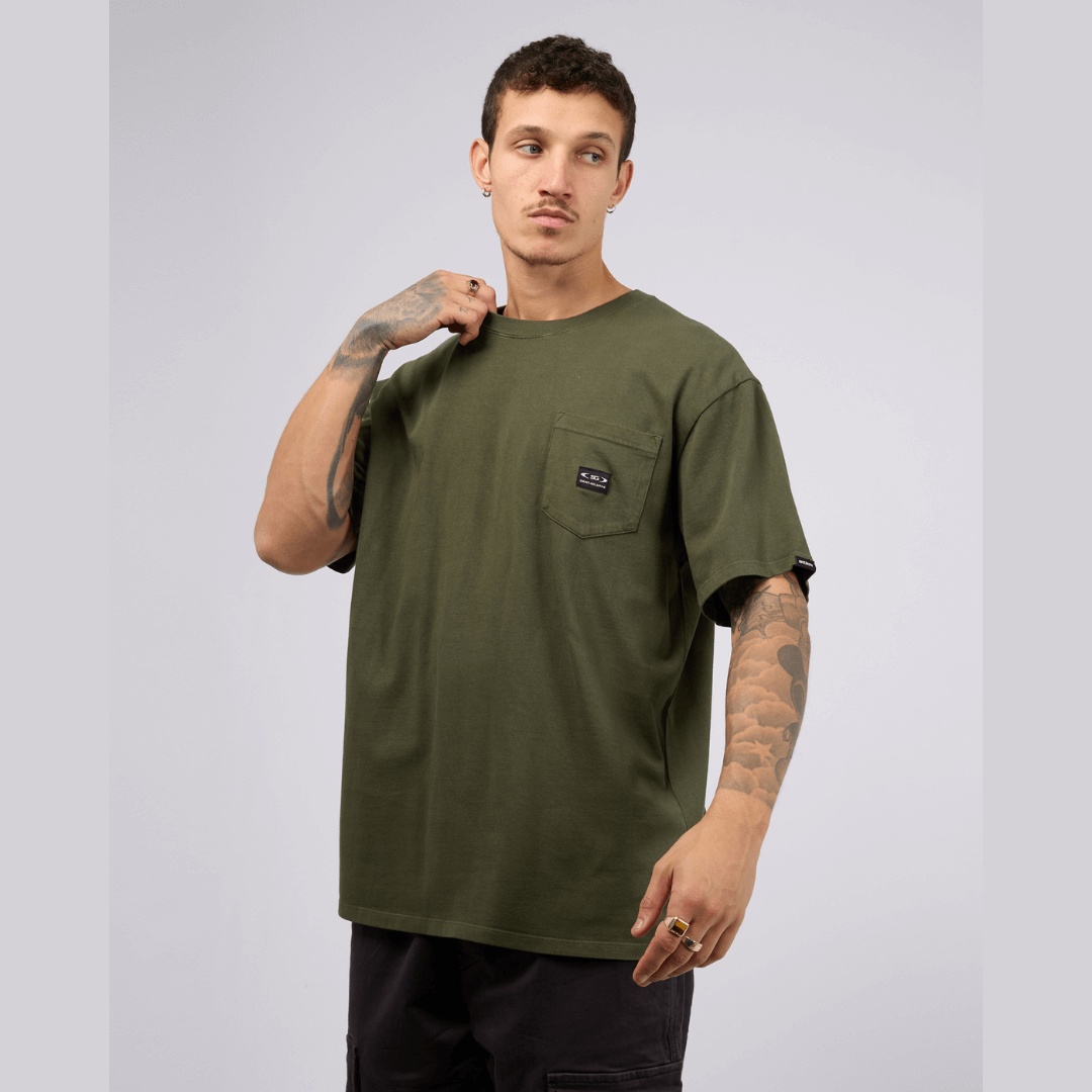 Stewarts Menswear, Mullumbimby. St Goliath pocket tee. Colour is khaki featuring a chest pocket with woven badge. Photo shows front view.