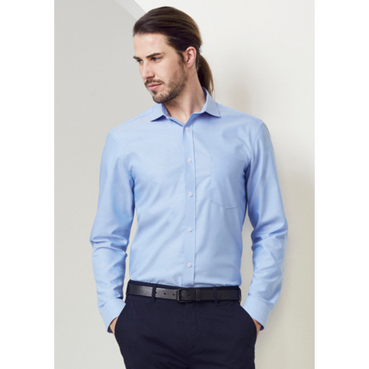 Model wearing Regent long sleeve shirt. Colour is light blue. Fabric is cotton.