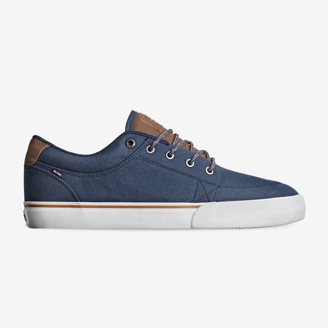 The Globe GS in Midnight is a vegan friendly skate shoe with a recycled PU/Canvas upper. A simple classic shoe featuring Globe's Shockbed insole for all day comfort, minimal padding and vulcanized construction for board feel and grip. Navy blue upper with tan coloured PU trim and white vulcanised sole. Side View