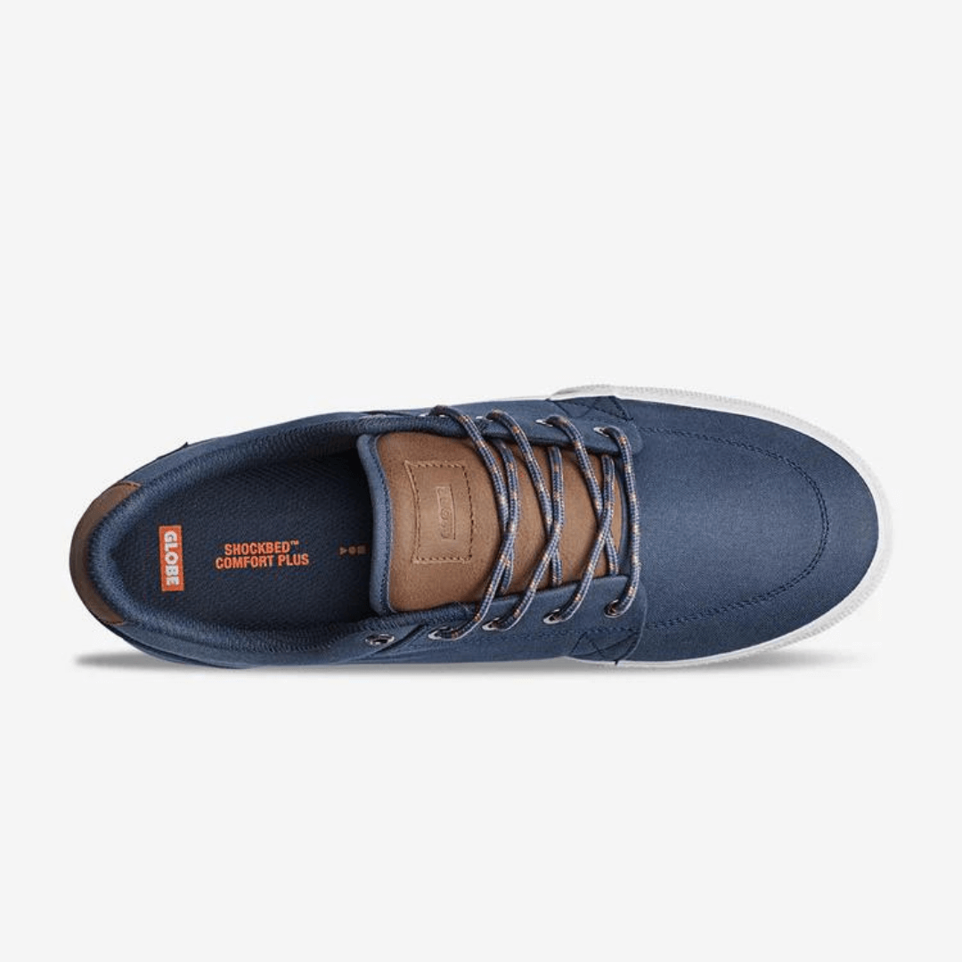 The Globe GS in Midnight is a vegan friendly skate shoe with a recycled PU/Canvas upper. A simple classic shoe featuring Globe's Shockbed insole for all day comfort, minimal padding and vulcanized construction for board feel and grip. Navy blue upper with tan coloured PU trim and white vulcanised sole. Aerial  View