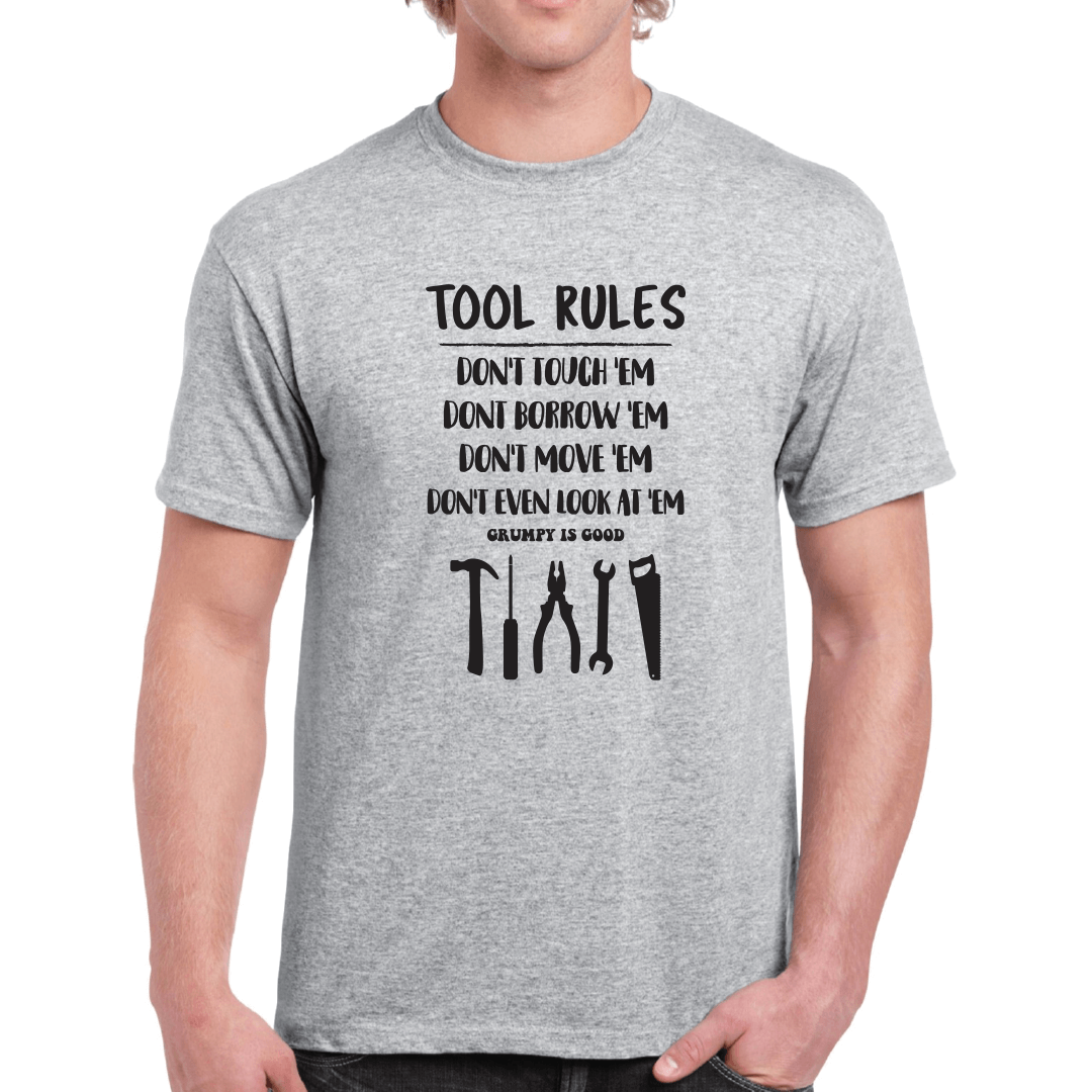 GRUMPY IS GOOD ~ Tool Rules! A fun Dad's Shed themed slogan and the perfect gift for any man who enjoys wearing their personality and showing their confident style! Perfect for the "Grumpy Guy" in your life, give them a tee shirt they’ll wear and wear! Grey T-Shirt with black print. Slogan reads: Tool Rules Don't Touch 'Em, Don't Borrow "Em, Don't Move "Em, Don't even look at "em,
