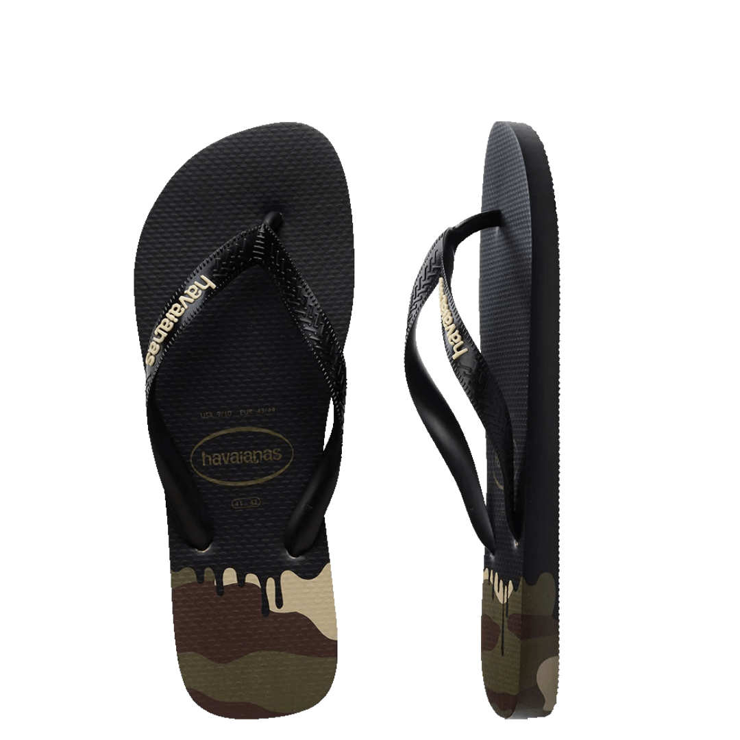 Shake up your Summer look with these new season thongs. Havaiana Top Ink print are the latest to hit stores this month. These black thongs have a black strap with sand coloured raised rubber logo. The black foot bed turns into a dripping ink look over a camo coloured heel. Side view of thongs.