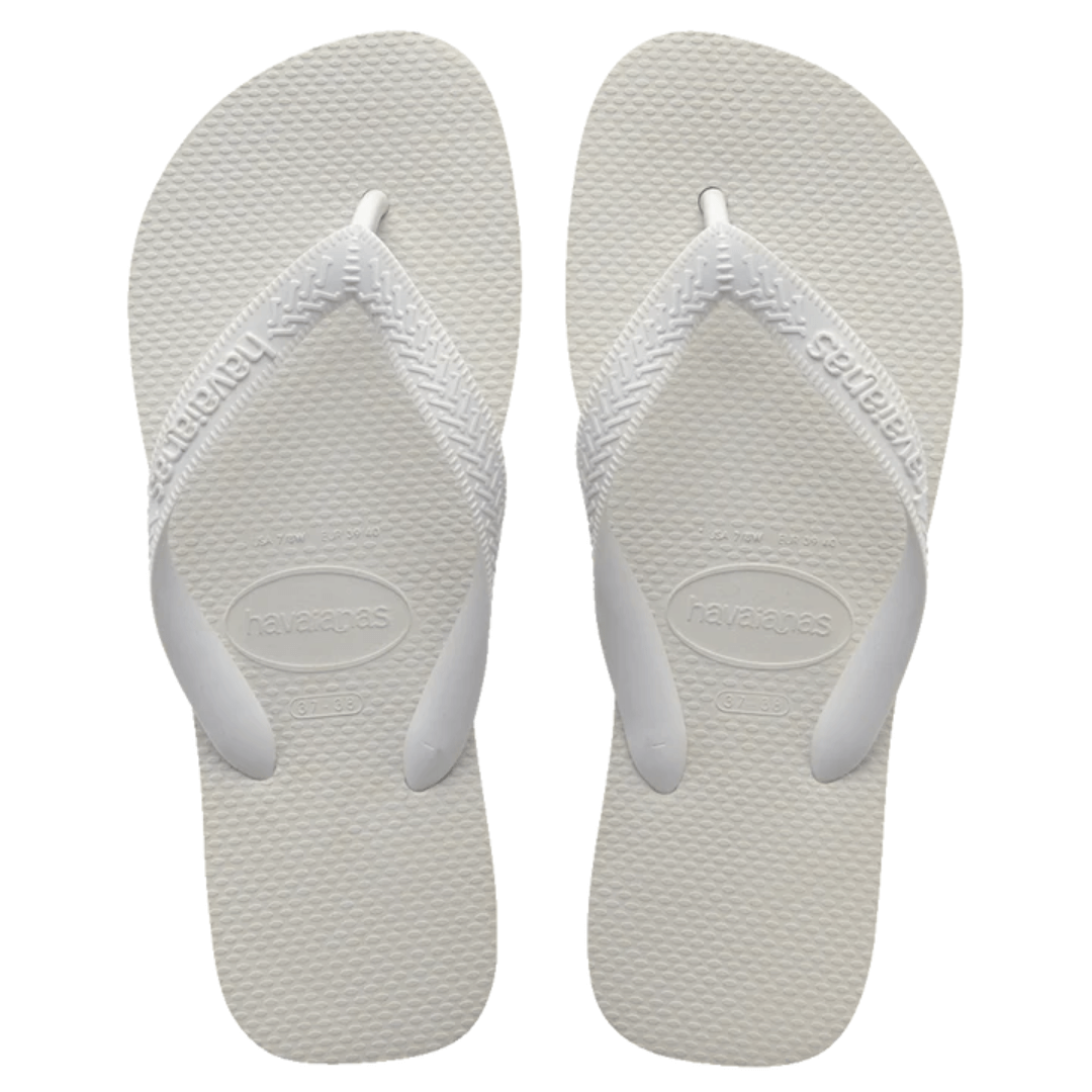 Stewarts Menswear Havaiana Top, White. Get ready to hit the beach with a summer staple, the Havaiana Top Thongs. A pair of basic thongs are a must have for your summer wardrobe.  Made in Brazil, since 1962, Havaianas were inspired by the Japanese Zori sandal.  Overhead view of a pair of Havaiana Top thongs. Footbed, straps and logo are all coloured White.