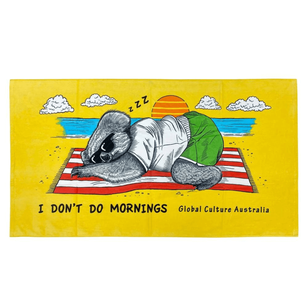 Stewarts Menswear Mullumbimby 100% cotton/velour beach towel with fun Australian theme print - Bright yellow background with sleeping koala at the beach on a red and white stripe towel and slogan "I don't do mornings". Perfect gift for friends or relatives overseas or as a souvenir of your trip to Australia. Size 84cm x 148cm