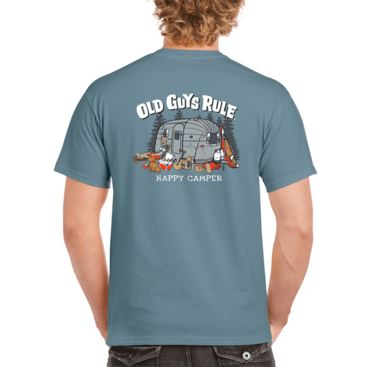 Stewart's Menswear Old Guys Rule Happy Camper Men's T-Shirt. A stone blue 100% cotton men's T-shirt with novelty print. "Happy Camper". Print is a picture of a man sitting outside a vintage caravan with his dog, esky, canoe and guitar . Old Guys Rule men's novelty print Tee shirt.