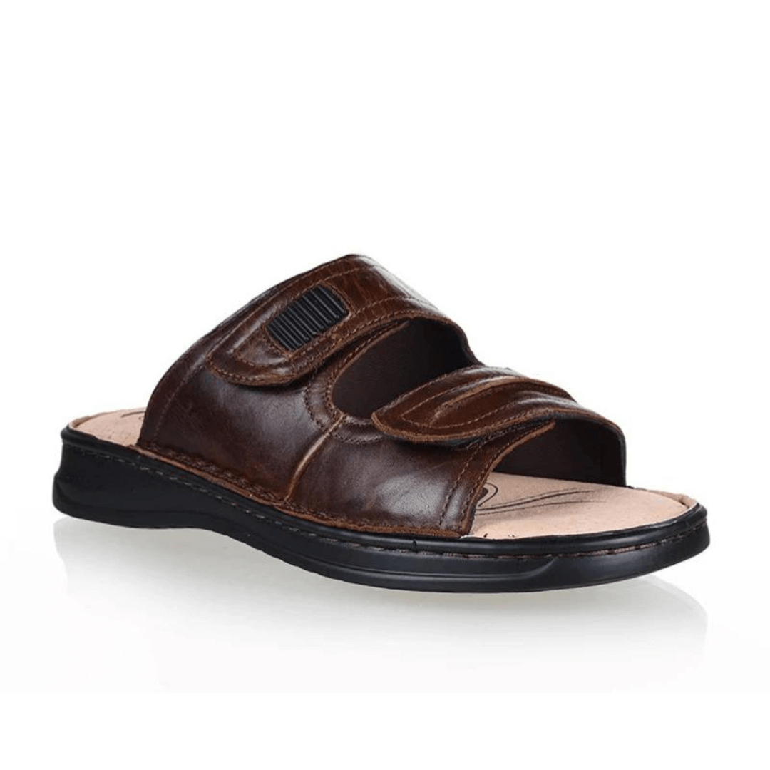 Stewart's Menswear Woodlands Gerard Leather slide. Gerard leather slides by Woodlands are the perfect everyday leather slide for men. With adjustable straps, they fit any foot.  Whether you have a narrow or wide foot, you can easily adjust the straps to ensure a perfect fit.  Features a leather upper and lining plus the padded insole will keep your feet feeling comfortable all day long. Side view